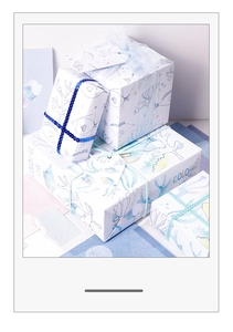 Colorful ocean theme gift wrapping paper boxes with ribbons and decorative tags