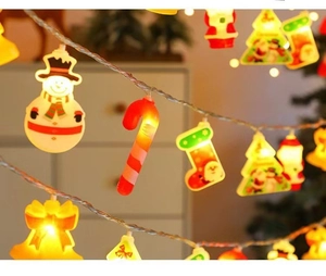 Close-up of LED Christmas string lights with snowman, Santa, and tree shapes