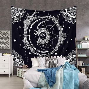 Detail of bohemian mandala tapestry featuring sun and moon patterns in a bedroom setting