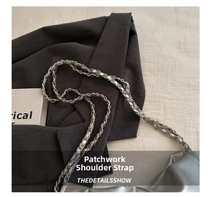Detail of silver pleated leather shoulder bag with woven metal chain and leather strap