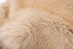 Macro shot of light brown faux fur texture showing soft and dense fabric detail