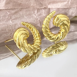 Polished golden twist rope earrings in retro spiral design for women on a white base