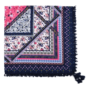 Detail showing bohemian square scarf with dark blue floral paisley patterns and tassels