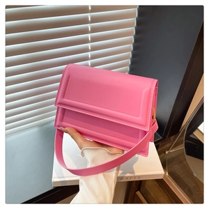 Detail showing high-quality pink PU leather texture and flap cover of the square handbag