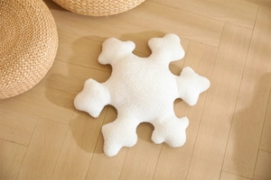 Detailed texture of a white snowflake pillow case made of soft sherpa fleece fabric
