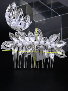 Macro view of silver bridal hair comb with rhinestones and crystal flower detail