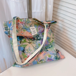 Close-up of vibrant floral canvas tote bag with artistic green oil painting pattern