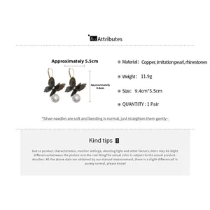 Detail view of lace butterfly pearl earrings showing dimensions 9.4cm x 5.5cm and materials