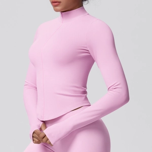 Detail view of pink ribbed yoga jacket featuring zipper collar and functional thumb holes