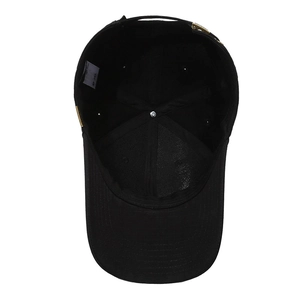 Internal view of black cotton baseball cap showing metal buckle and 100% cotton label