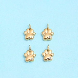 Set of four gold stainless steel cat paw charms with sparkling white zircon stones