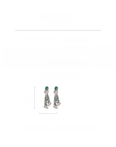 Macro view of vintage tassel earrings with green heart gems and silver rhinestone fringe