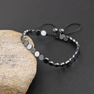 Adjustable hematite beaded bracelet featuring geometric hexagonal beads on a black cord
