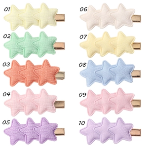 Flat lay of 10 colorful fabric star hair clips with numbered labels for color selection