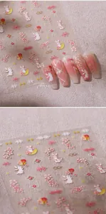 Detail of 3D gold nail stickers featuring rabbit and cherry blossom on long nails