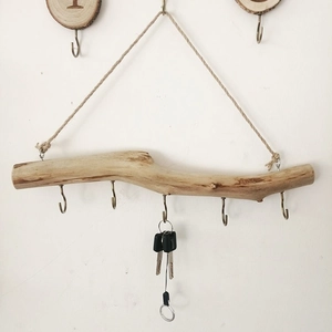 Rustic driftwood wall hook with 5 metal hangers and hemp rope on white background