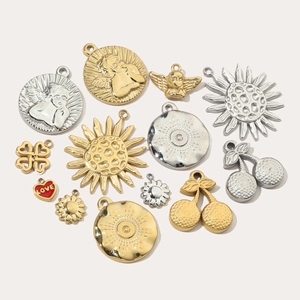 Assorted gold and silver stainless steel pendants including heart, angel, and flower shapes