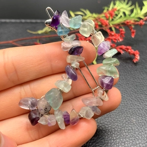 Close-up of crescent moon hair clip crafted with colorful natural crystal stones and wire