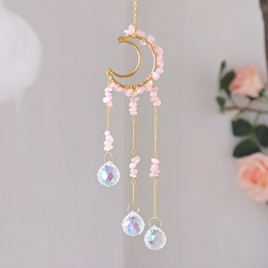 Detailed moon-shaped suncatcher with pink crystals and shimmering prisms for room decor