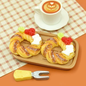 Miniature Christmas resin pastry set with coffee cup and fork on a brown serving tray