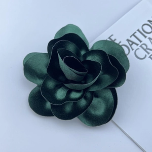 Detailed view of the dark green 3D satin rose brooch with elegant fabric layers
