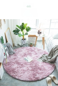 Detail of soft pink purple round shaggy rug with high pile texture in a cozy room