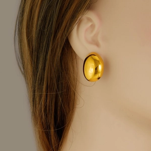 Polished 304 stainless steel gold oval dome stud earrings worn by a model