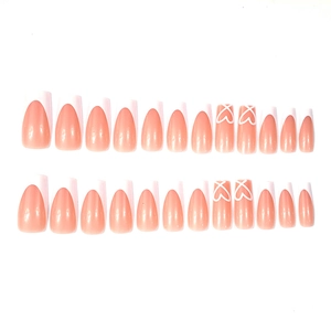French tip press-on nails set with minimalist white heart patterns on pink base