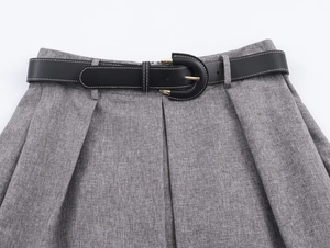 Detail of grey herringbone skirt waist with a slim black leather belt and gold buckle