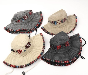 Four ethnic embroidered cotton bucket hats with adjustable chin straps in neutral tones