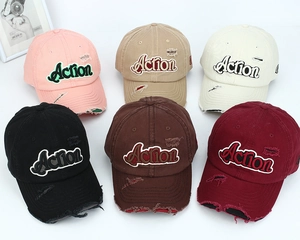 Collection of distressed baseball caps with Action embroidery in six vintage colors