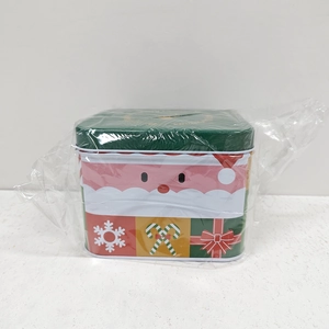 Detail of Christmas tin box featuring Santa Claus and candy canes with handle