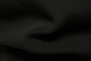 Detailed macro view of high-quality black knit fabric with tight texture and soft feel