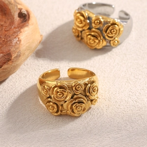 Macro shot of 18K gold plated vintage rose flower relief ring with adjustable open band