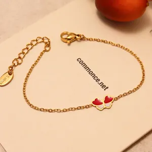 Bracelet en acier inoxydable doré avec pendentif papillon en émail rouge et blanc