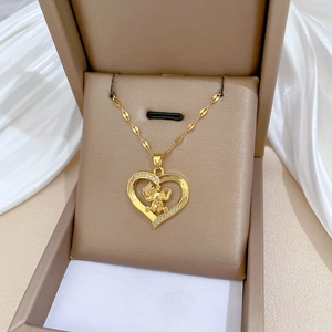Elegant gold heart elephant necklace with pavé crystals on silk background