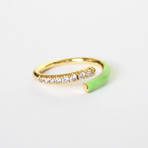 Macro view of gold ring featuring micro-pave zircons and light green enamel detail