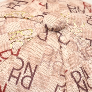 Detailed macro view of the baseball cap crown with letter print and golden foil stamping