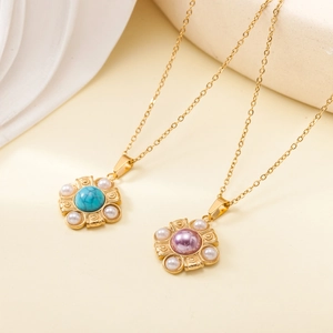 Detail of two gold flower necklaces with turquoise and purple stones plus pearls
