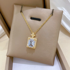 Detail of gold square zircon necklace with sparkling crystals on a jewelry display mat