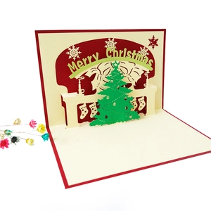 Close-up of a 3D pop-up Christmas tree card featuring an intricate green cutout design