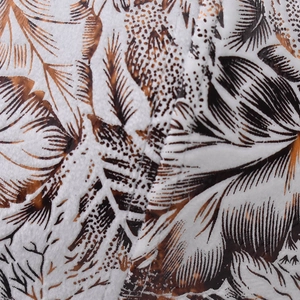 Close-up of soft cotton fabric texture with vintage brown floral and leaf prints