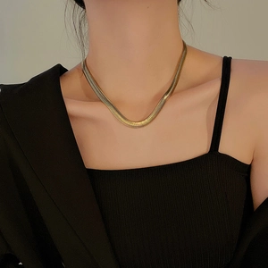 Elegant gold snake bone chain necklace shown on a model neck with a glossy metallic finish