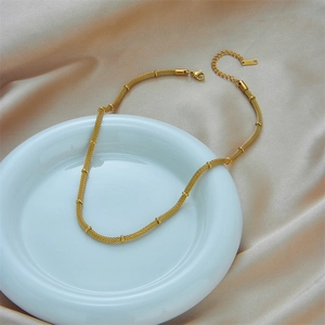 Minimalist gold woven mesh necklace in stainless steel with segment rings and lobster clasp