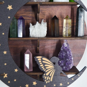 Detail of wooden crescent moon fairy shelf displaying various healing crystals and minerals