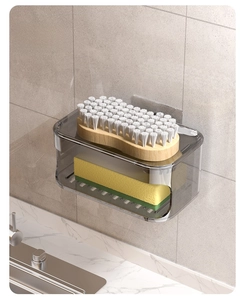 Macro detail of wall-mounted smoke gray drainage soap box with sponges and brush