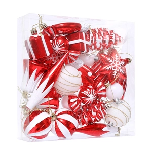Red and white Christmas ornament set including candy, star, and ball shapes in a clear box