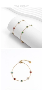 Detail of gold chain bracelet with colorful heart zircons and lobster clasp closure