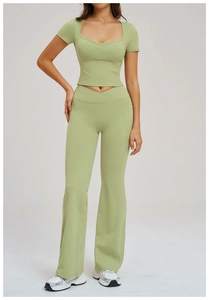 Detail of light green yoga set showing high waist crossover pants with side pockets