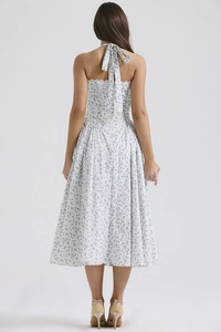 Detail of floral halter dress showing open back design and white ribbon bow tie back